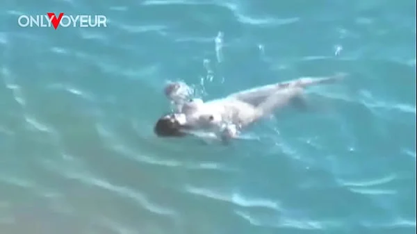 Beach Voyeur. Hot babe with big natural tits gives head on a public beach