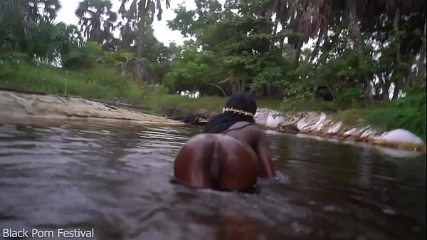 Skinny dark skinned African hottie teasing in the water