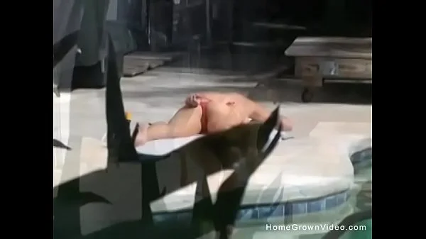 Big tit girlfriend giving a handjob outside by the pool