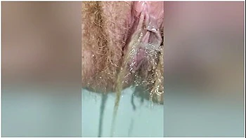 Detailed Close-up Footage Of A Hairy Pussy Girl Urinating From Her Pee Hole And Farting Loudly