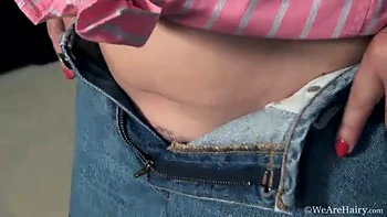 Kelly Lima strips naked on her brown couch - WeAreHairy