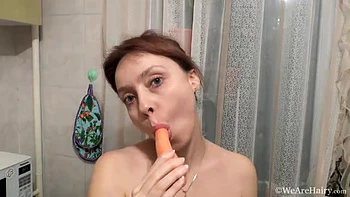 Trixie masturbates in her kitchen with a carrot - WeAreHairy