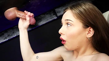 Cute teen Venus Vixen gets her hands on a big dick through a gloryhole.