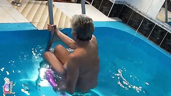 Gorgeous mature blonde Jitka is touching her shaved pussy in the pool